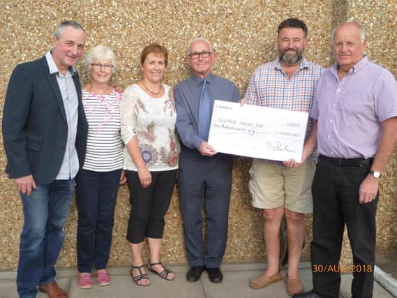 Whittingham Club festival committee members (from the left) Tony Dixon, Pat Parkinson, Heather Dixon, Ian Woods and Peter Parkinson present Rosemere Cancer Foundation volunteer ambassador Frank Stoner (fourth from the left), who chaired its 20 Years Anniversary Appeal Committee, with a 1,000 donation