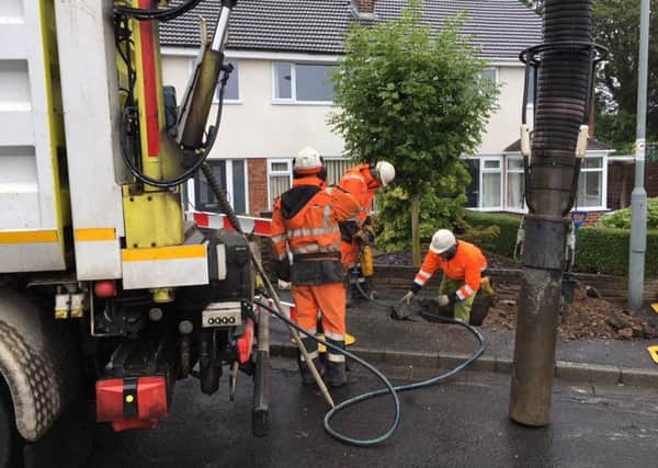 Engineers work on clearing the water from gas pipes