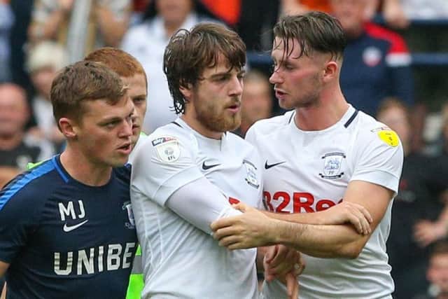 Ben Pearson is led away by PNE physio Matt Jackson and team-mate Alan Browne after the Bolton game
