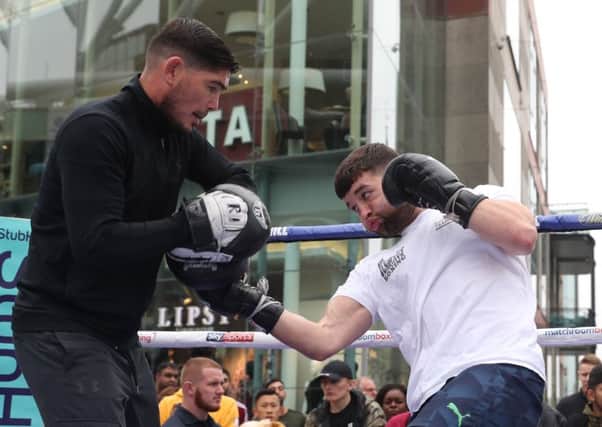 Scott Fitzgerald (right) is put through his paces by trainer Michael Jennings at the open training session in Birmingham on Tuesday