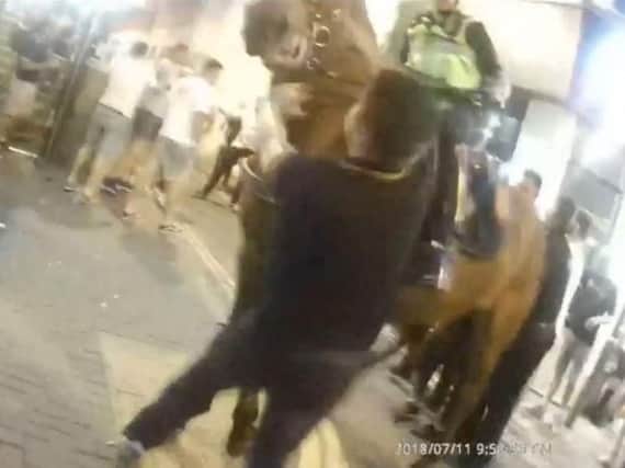 The moment Scott Spurling punched police horse Quantock outside Allstars bar in Weston-super-Mare, Somerset after England's World Cup semi-final defeat to Croatia. Photo credit: Avon and Somerset Police/PA Wire