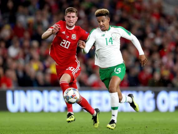 Callum Robinson takes on Wales' Chris Mepham when making his competitive debut for the Republic of Ireland
