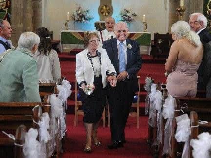 Walking down the aisle after their wedding