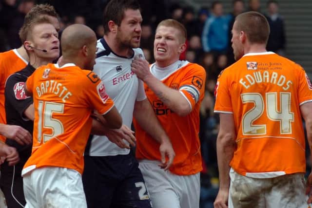 Parkin clashes with Blackpool players in a Lancashire derby in 2010