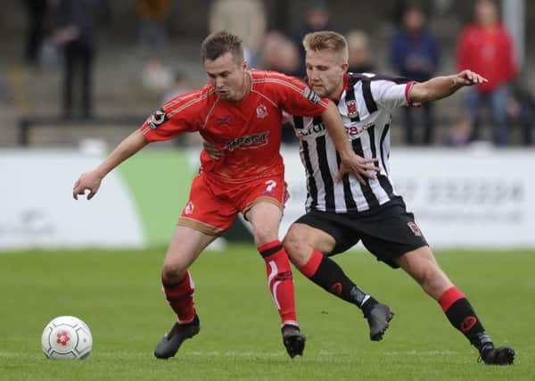 Bobby Johnson of Alfreton Town battles for the ball with Marcus Carver of Chorley  Photo: Greig Bertram