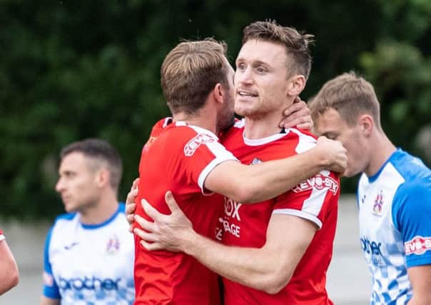 Kieran Charnock is congratulated by Alistair Waddecar after scoring against Stalybridge Celtic