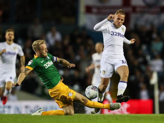 Preston captain Tom Clarke challenges Leeds' Samuel Saiz