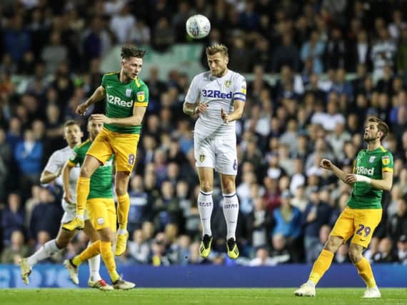 PNE midfielder Alan Browne challenges with Liam Cooper