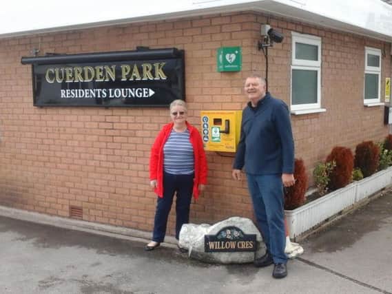 John Thomson and Margerry Bradley with the defibrillator at Cuerden Residential Park
