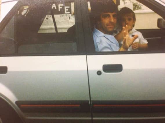 Dennis Higgins and his son in his prized car in 1988