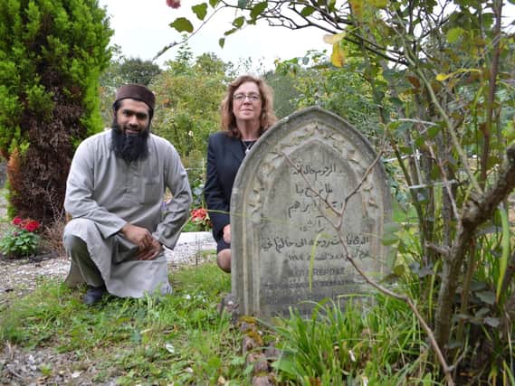 Imam Amjad Yusuf, from Fulwood Mosque, and Julie Knifton, clerk at Preston Cemetery, by the grave of Achmed ben Ibrahim