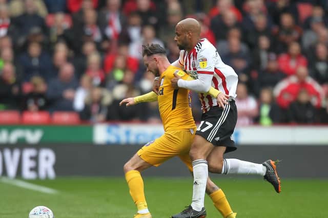 Preston midfielder Alan Browne battles with Sheffield United match-winner David McGoldrick