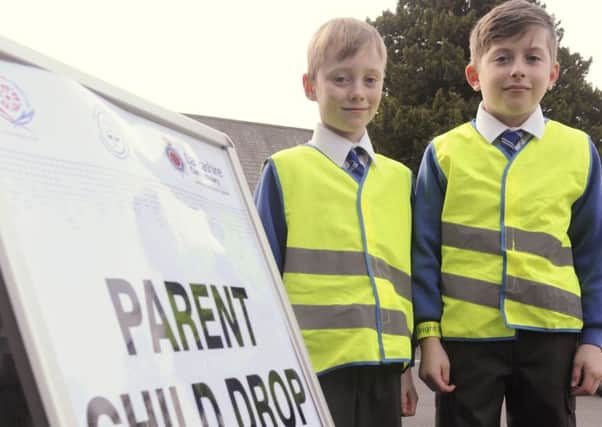 A new drop-off system has been introduced for parents delivering their children to St Mary and St Michael's RC School in Garstang.  Pictured are pupils Luke Dodd and Luke Wilkinson.