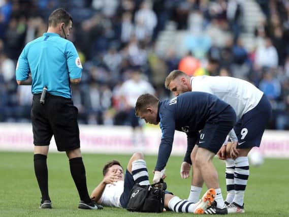 Josh Harrop is attended to after being injured against West Bromwich Albion