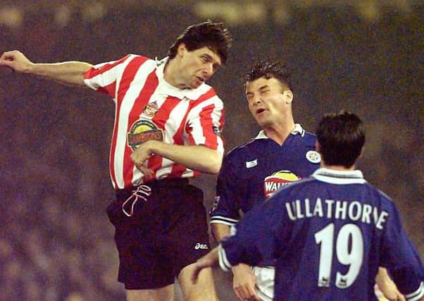 Steve Walsh goes up for an aerial duel with Niall Quinn