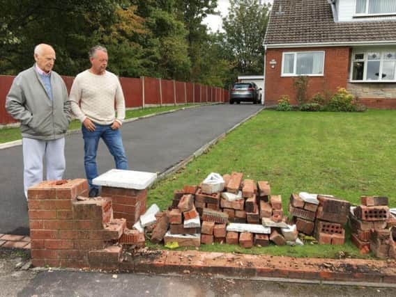 James Roberts and son-in-law Mick Whiles survey the damage