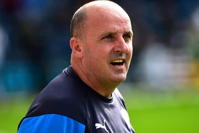 Wigan boss Paul Cook looks on at Deepdale