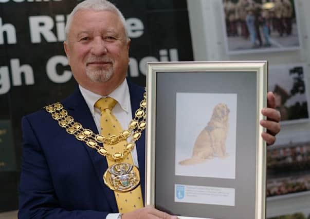 Mayor of South Ribble, councillor John Rainsbury with the framed photo of Worden the guide dog.