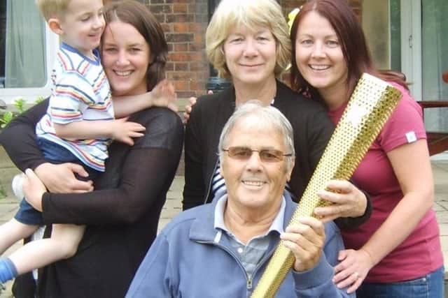 Margaret with husband Kevin and family in 2012 with the Olympic torch