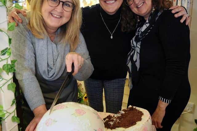 Toni (centre) with Lynne (left) and Jill from Iced share out the launch cake