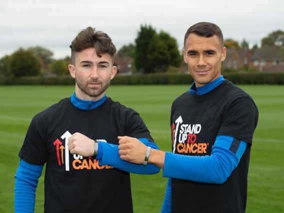Sean Maguire and Graham Burke show off the Stand Up To Cancer wristbands