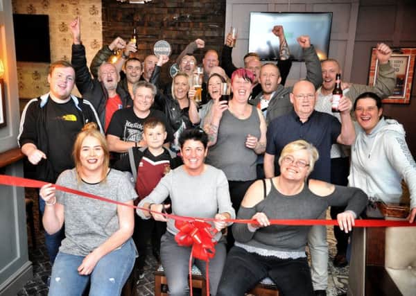 Picture by Julian Brown 12/10/18

The pub is officially opened! Pictured front left, Shannon Brannelly landlady, cutting the ribbon Tina Igo, Marston area manager and Andrea Brannelly, the other landlady 

Offical reopening of The Plough, Chorley