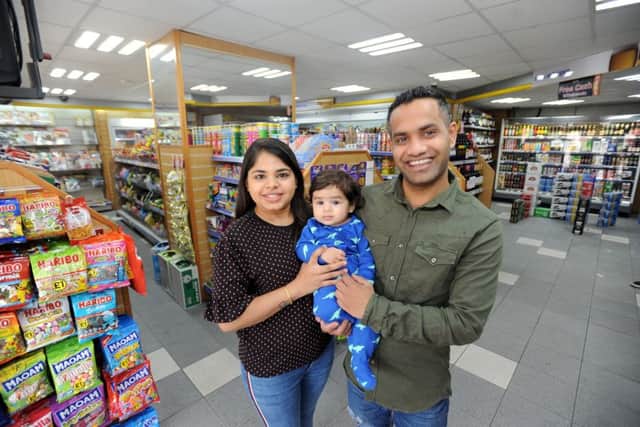 Taking over the conveniencer store  is Feni and Sumit Patel pictured holding Jiyan Patel.