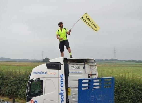 A fracking protester on top of a lorry in 2016