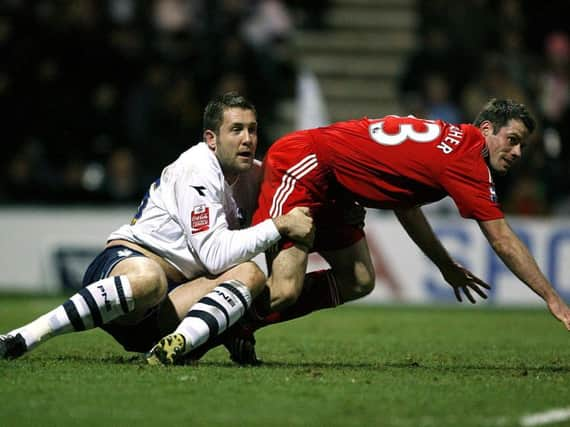 PNE striker Jon Parkin gets to grips with Liverpool defender Jamie Carragher