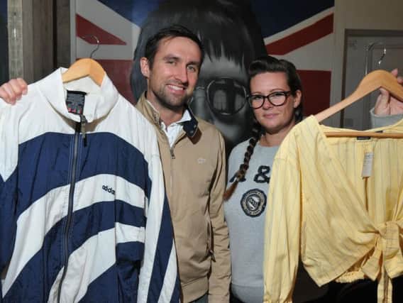 Brad Asquith and Lisa Kirby with some of their authentic retro clothes.