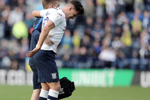 Josh Harrop is helped off after damaging his knee against West Bromwich Albion