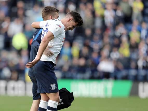 Josh Harrop is helped off after damaging his knee against West Bromwich Albion