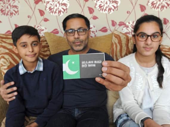 Paz Akhtar with the leaflet that was hand-delivered to his home and his nephew and niece