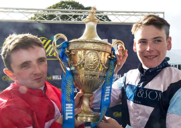 Jockeys Cameron Noble (right) and Chris Hayes (left) celebrate with the trophy after finishing in a dead heat in the The William Hill Ayr Gold Cup in September