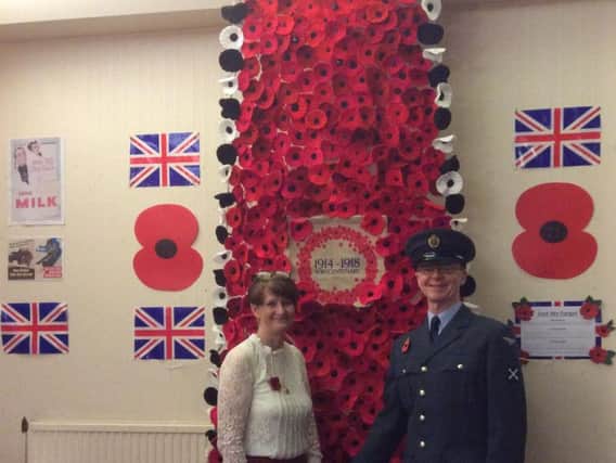 Glynis Hodges and Peter Finch with the wall of poppies at Lea Club, Blackpool Road, in Preston
