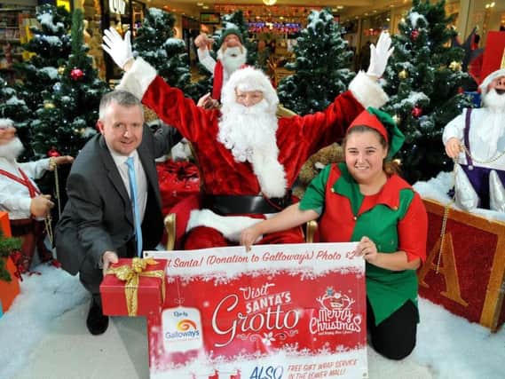 Santa with Chief Elf Charlotte at last year's launch of Galloway's Santa's grotto at St George's Centre, with manager Andrew Stringer