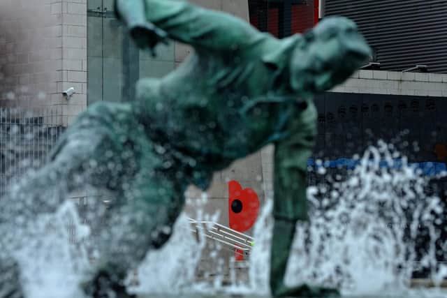 The statue of Sir Tom Finney showing the red poppy on the side of Deepdale as part of this year's national Poppy Appeal