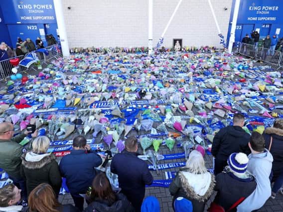 Supporters pay tribute at Leicester City Foootbal Club following a helicopter used by club owner Vichai Srivaddhanaprabha, crashing into flames in a car park near the stadium shortly after 8.30pm on Saturday evening. Picture: Aaron Chown/PA Wire