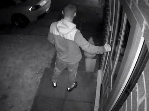 CCTV of a would-be intruder trying the door in Leyland