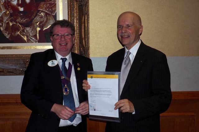 Lion David Thomas  (right) receiving a letter of appreciation for 25 years membership of Lions Clubs International.