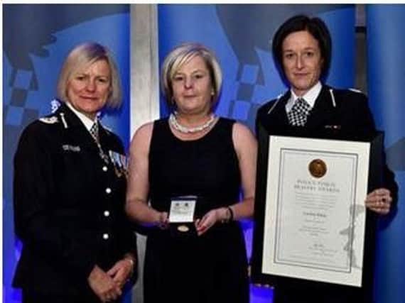 Caroline Ridley, centre, being presented with her bravery award