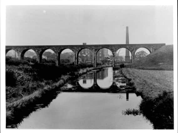 Nine Arches Viaduct, in Chorley, which was demolished in November 1968. Botany Bay shopping complex can be seen in the background.
