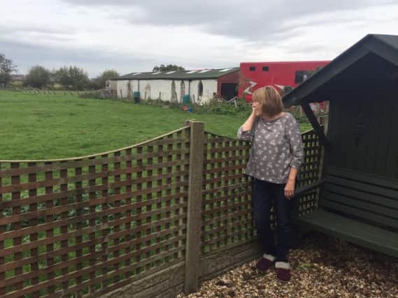 Liz Phillips at the garden fence which will be two metres from a new house.