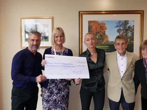 Tim Elliott, Lyn Clement, John and Margaret Elliott present a cheque to  the ward sister at Royal Preston Hospital's critical care unit