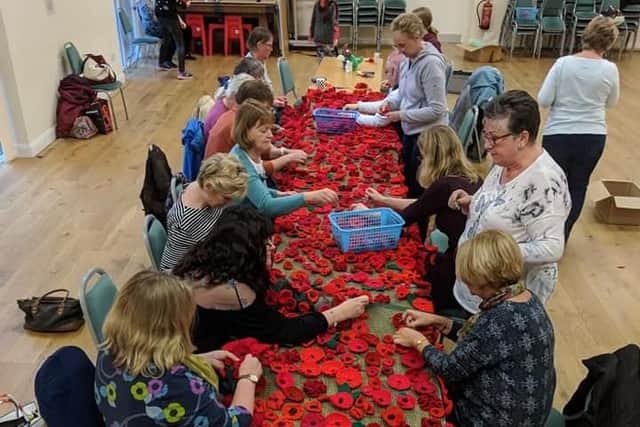 Community team work -  preparing the poppy tributes
