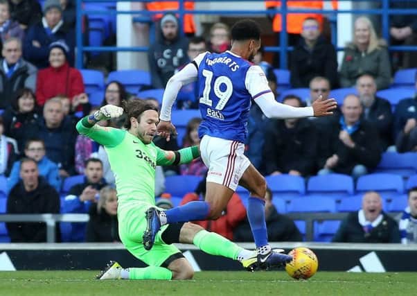Chris Maxwell concedes a penalty after bringing down Ipswich Town's Jordan Roberts which led to his first yellow card