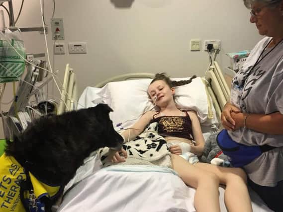 Imogen Stanway with a guide dog at hospital