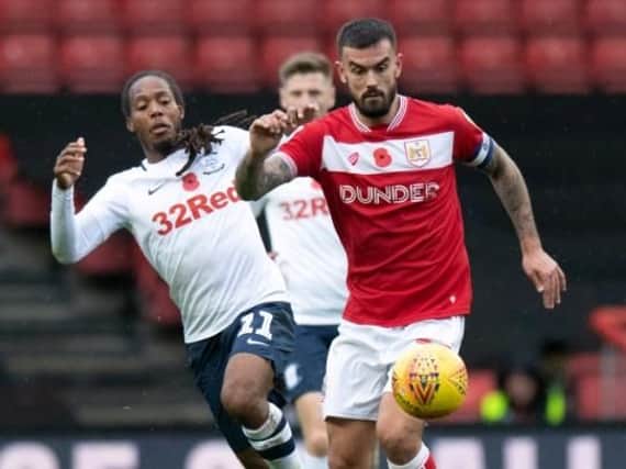 Daniel Johnson battles with Bristol City captain Marlon Pack