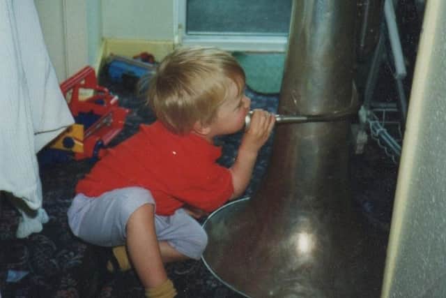 Early talent: Dan has a go on his father's tuba at the age of two