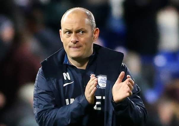 Preston manager Alex Neil applauds the travelling PNE supporters at Ipswich